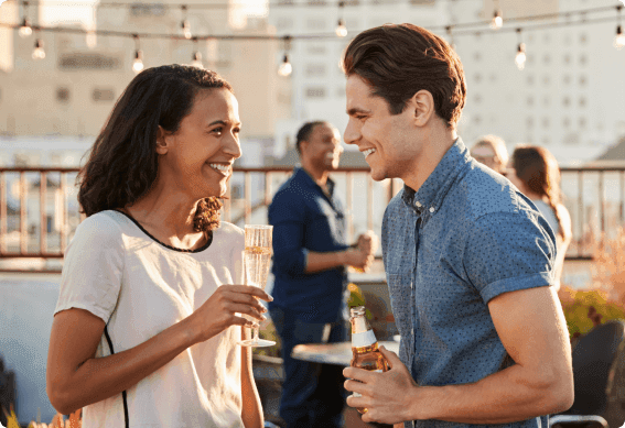 a man and a woman holding drinks