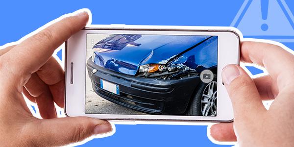 someone looking at a photo of a damaged car