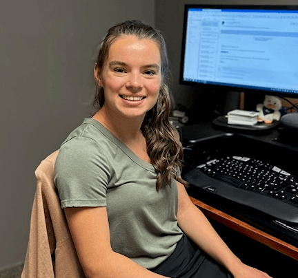 a woman sitting in front of a computer