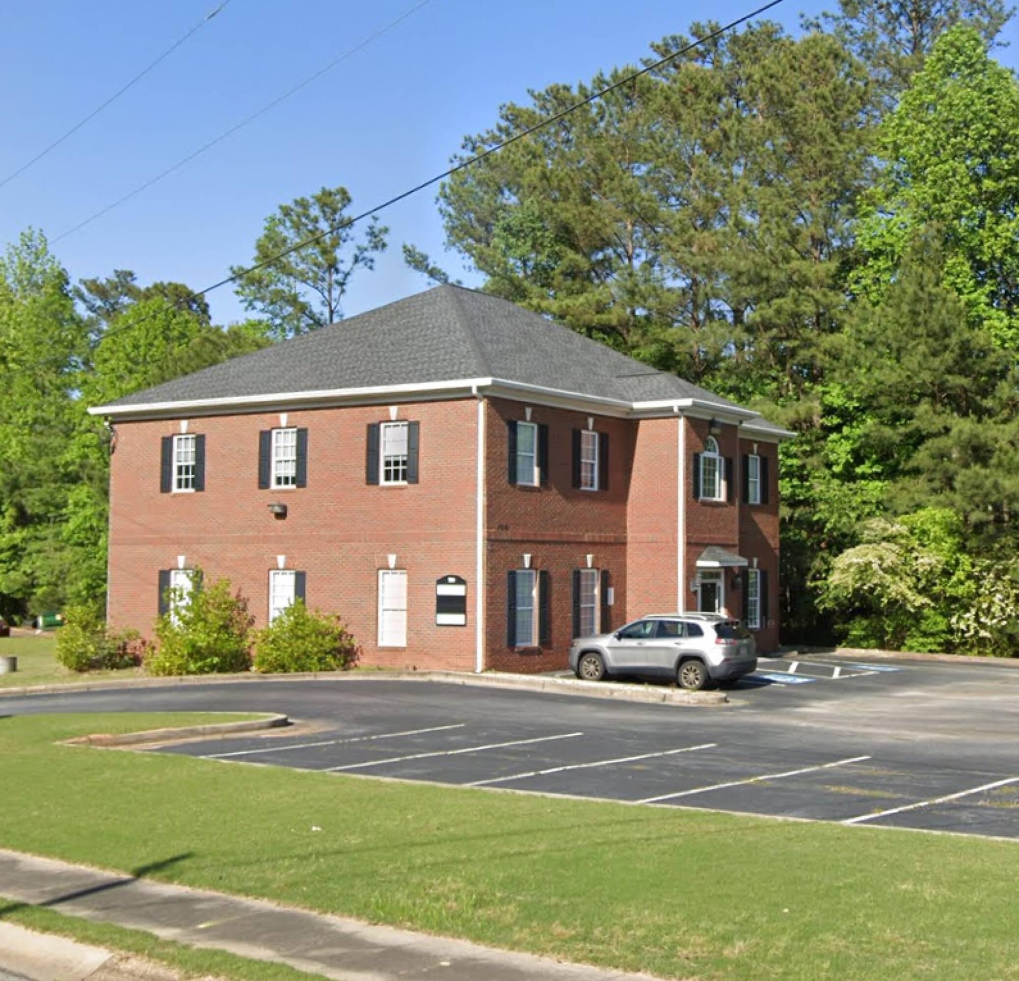 a car parked in front of a brick building