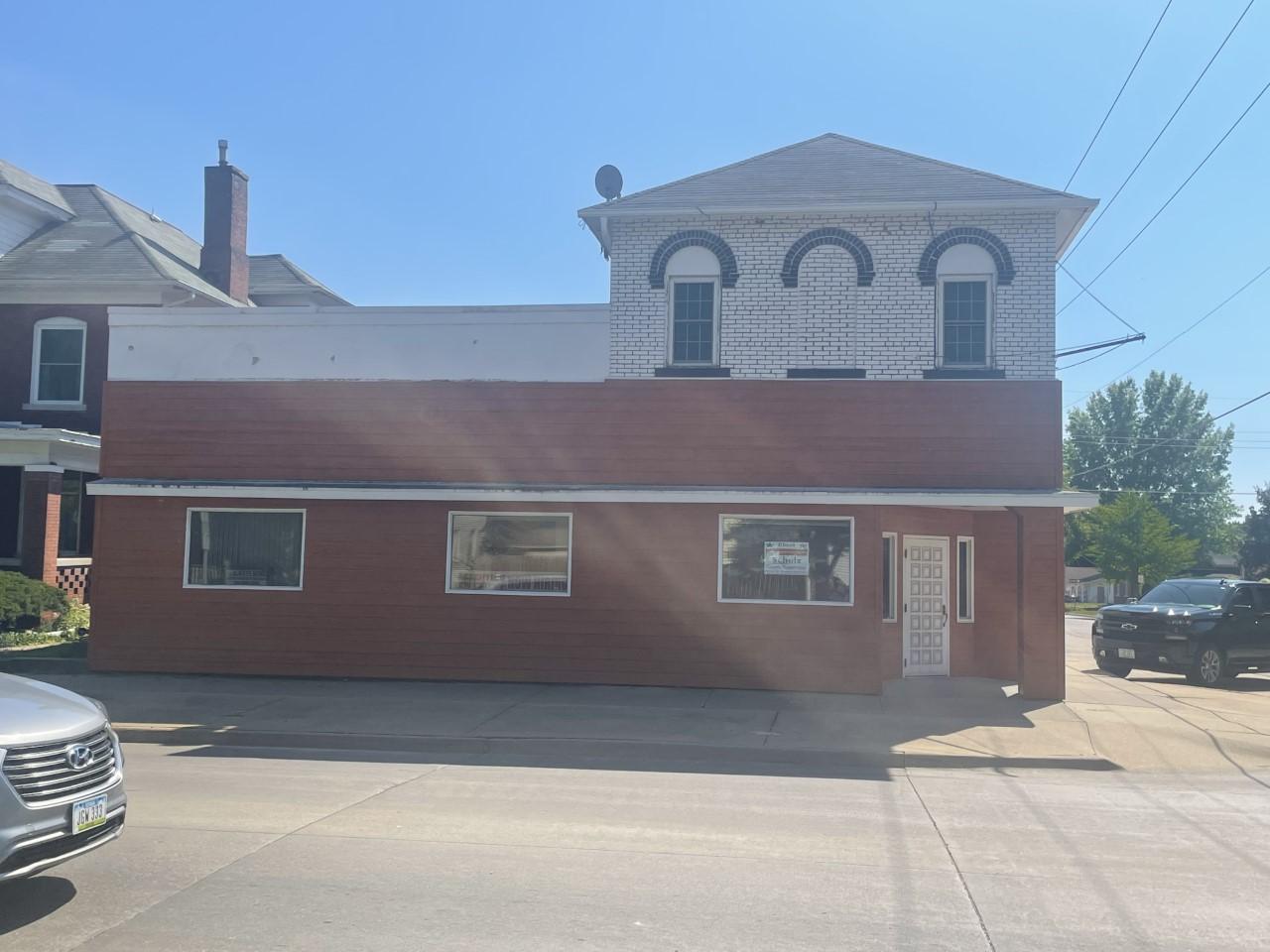 a brick building with a car parked in front of it