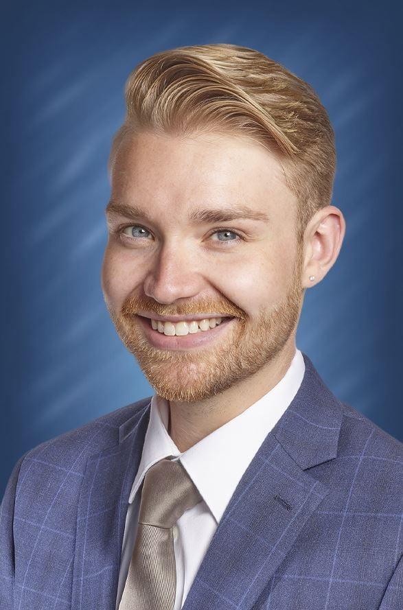 a man in a suit smiling