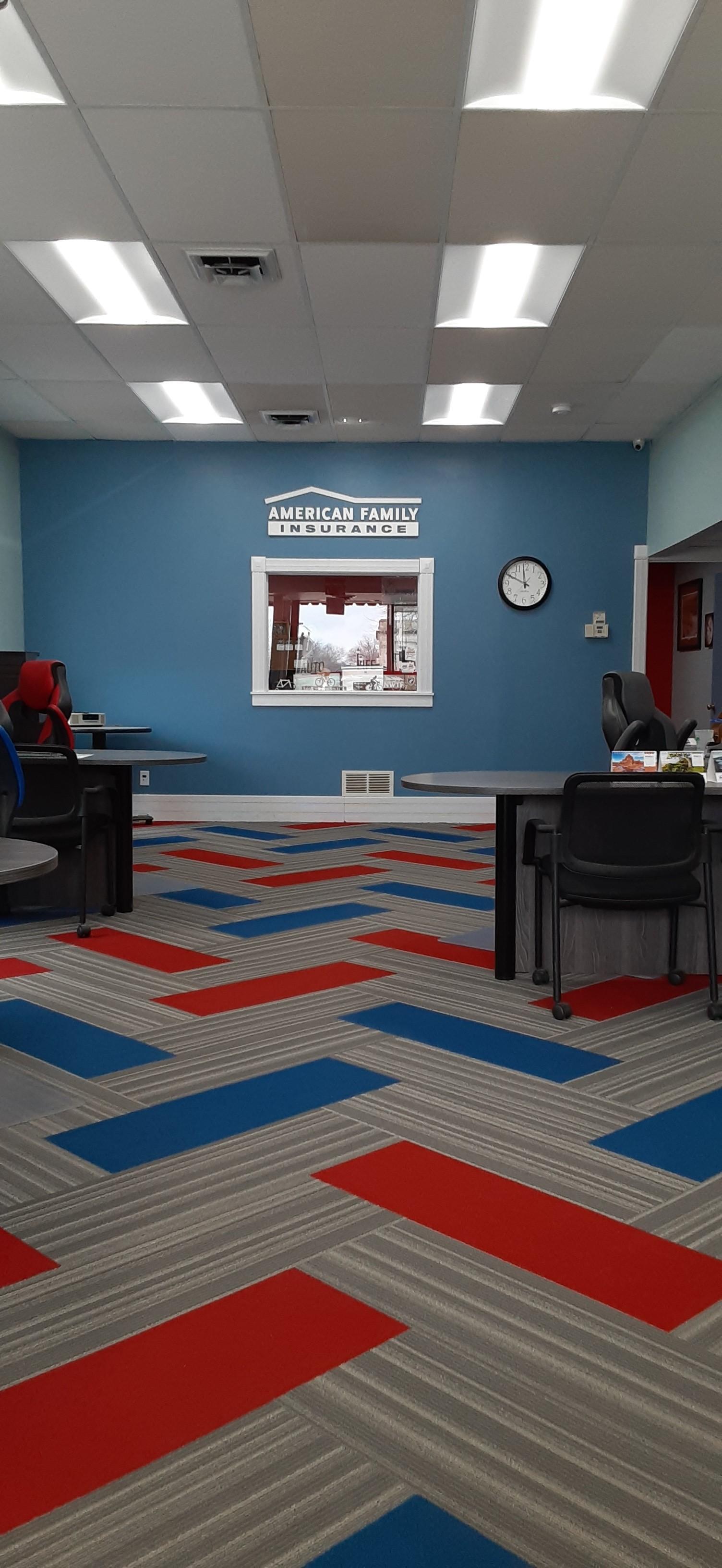 a room with a blue wall and a desk with a clock