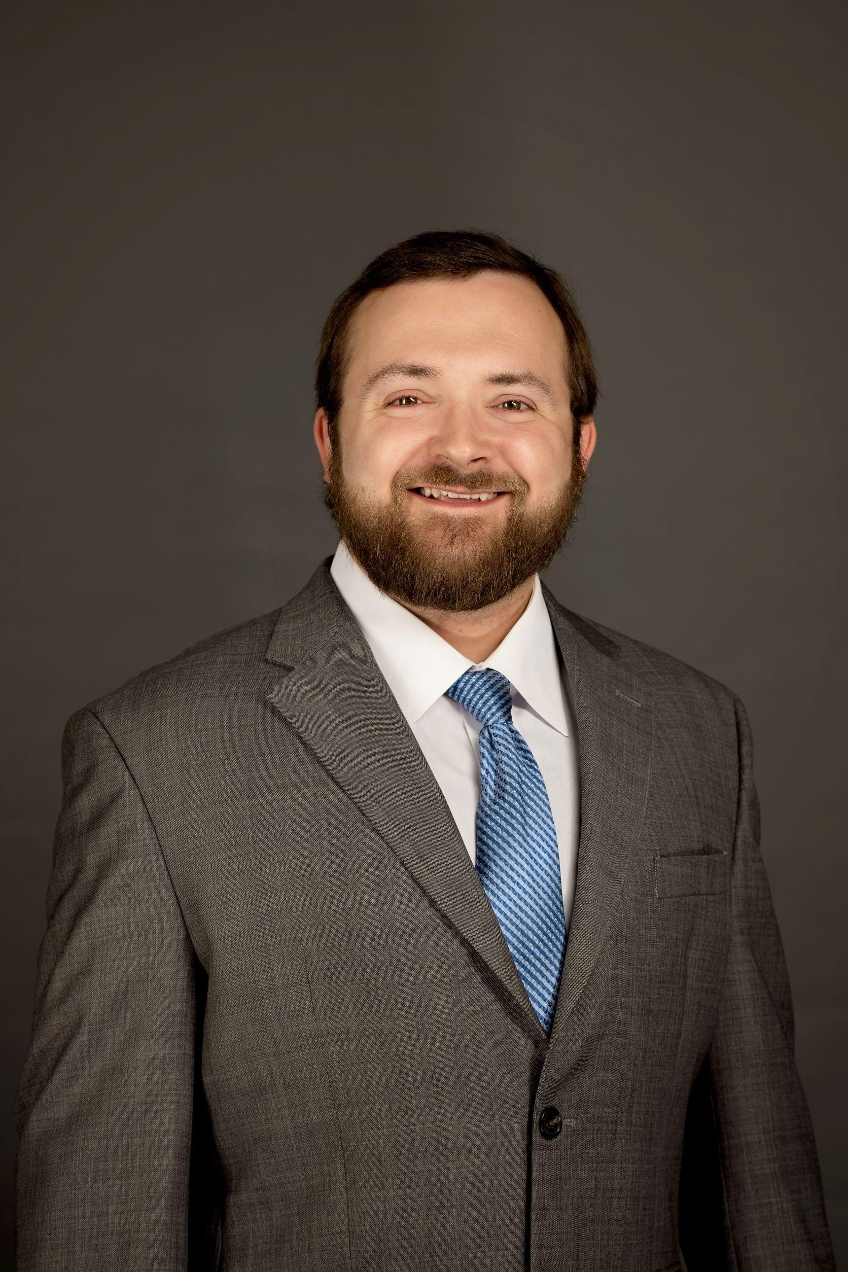 a man in a suit smiling