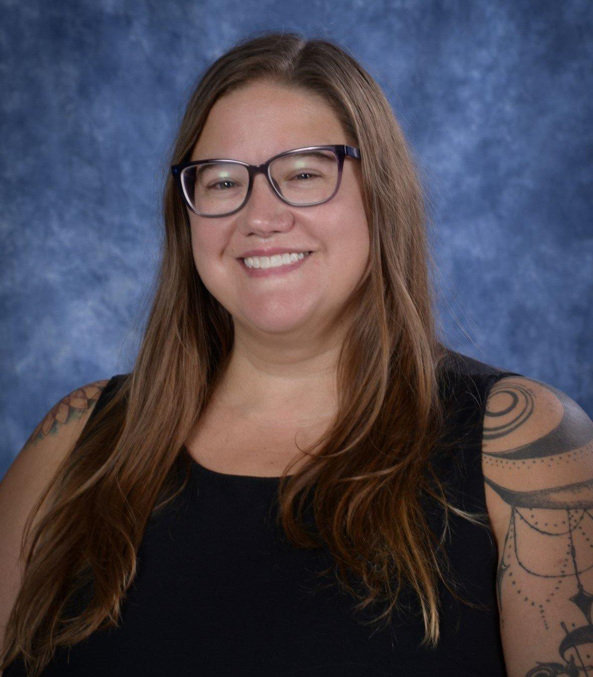 a woman with long hair and glasses