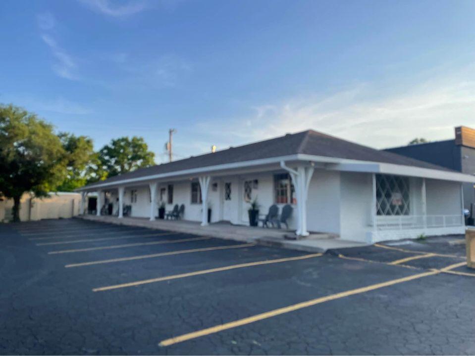 a building with columns and a parking lot