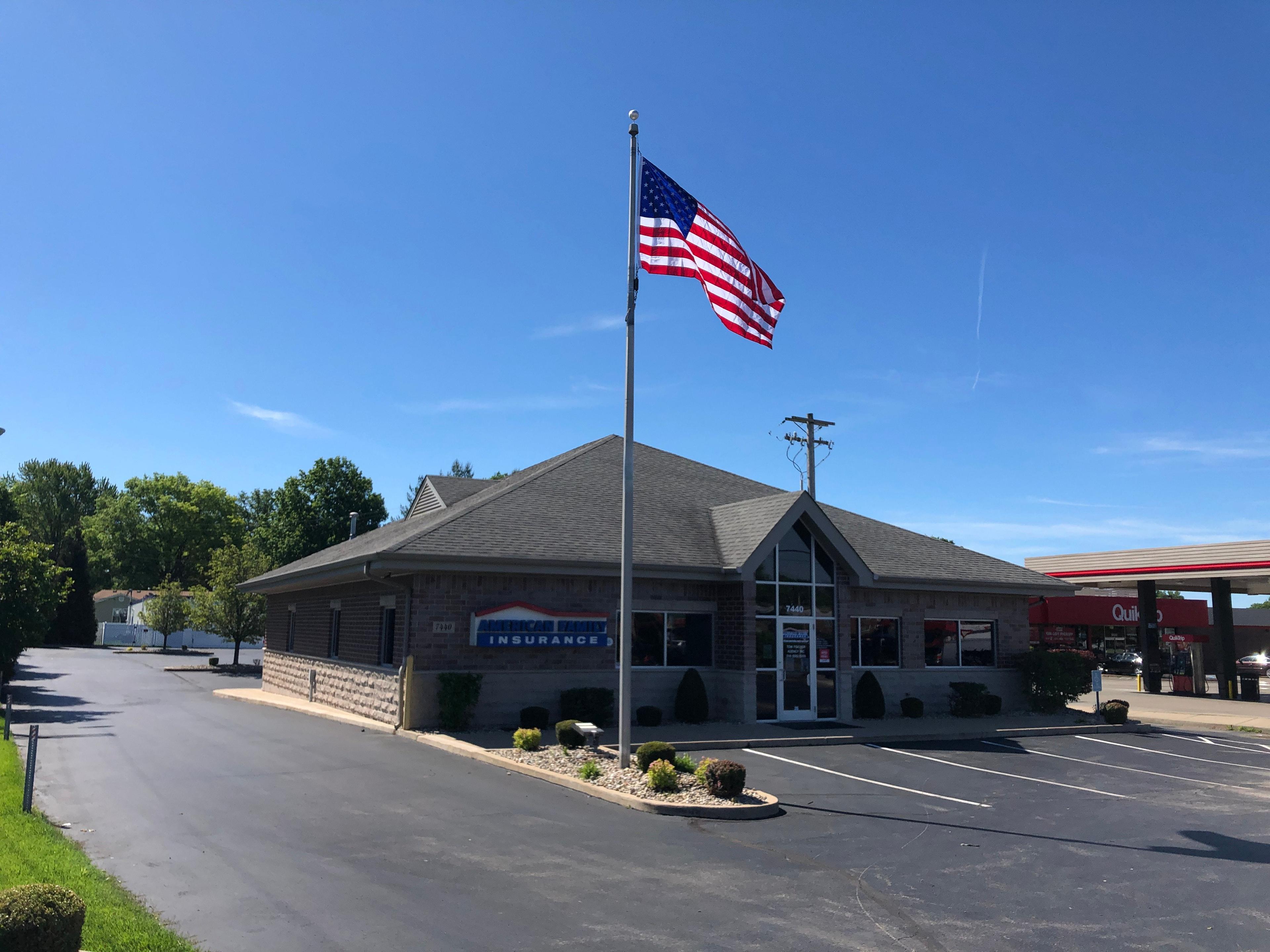 a flag on a pole in front of a building