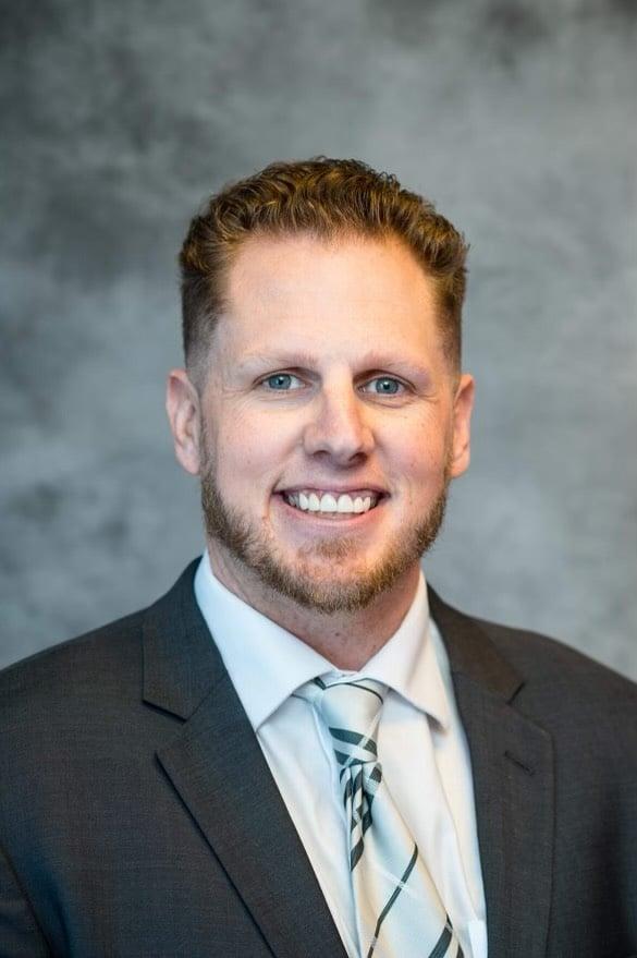 a man in a suit smiling