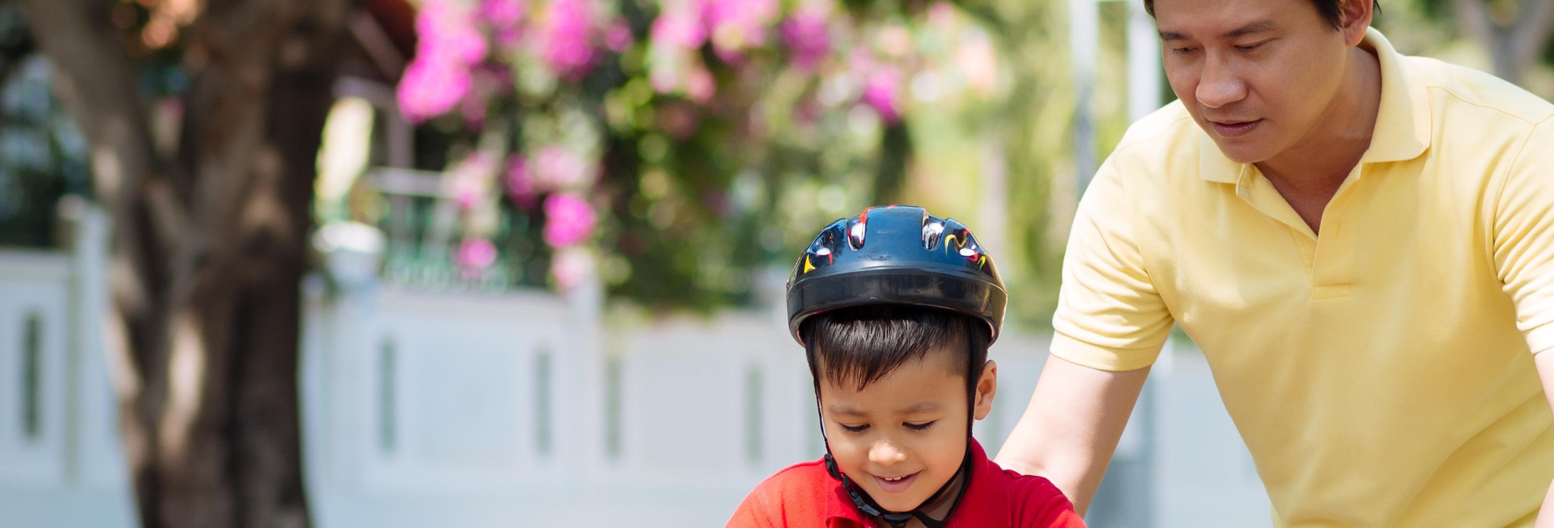 a child learning to ride a bike