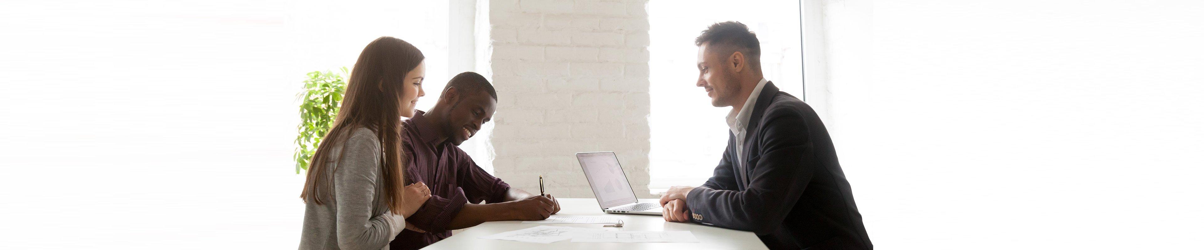 Young couple with lender dealing with earnest money. 