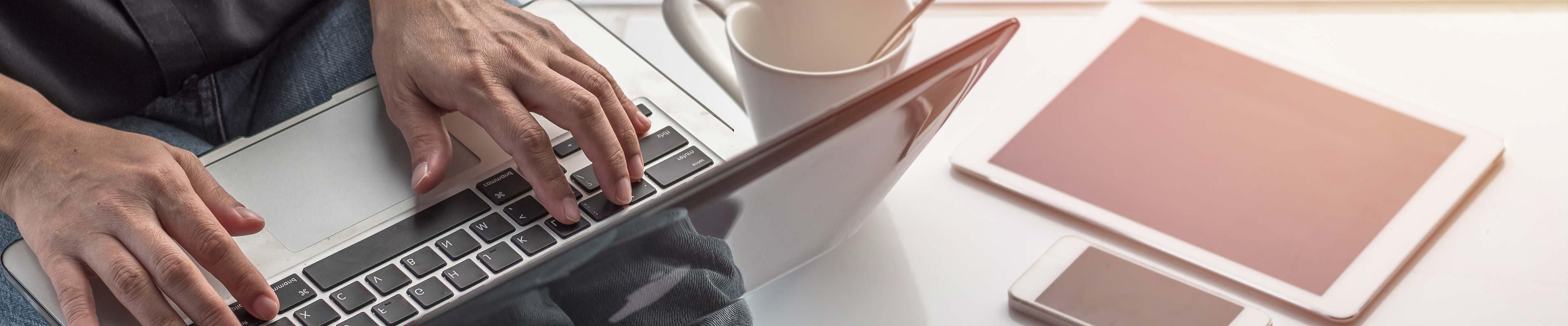 Man using laptop to set up smart home