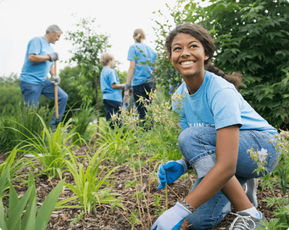 A group of young volunteers working in a park.