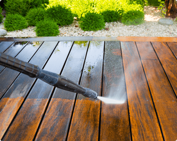 Power washer cleaning wood floor