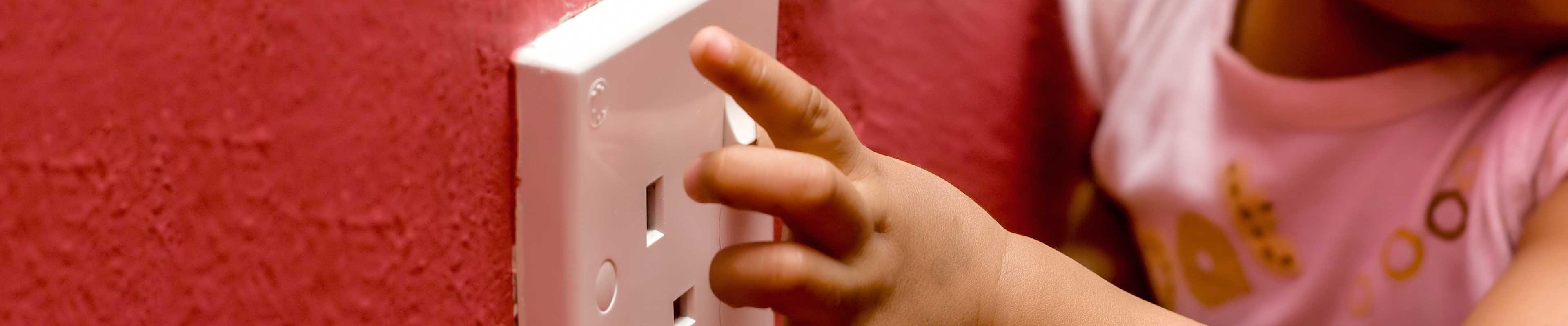 Toddler playing with an outlet