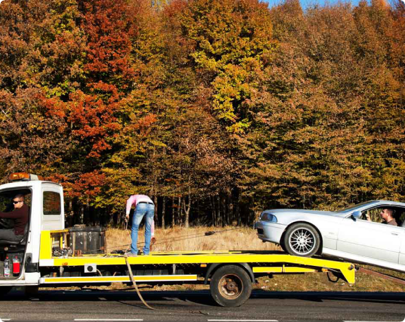 A car getting towed from the side of the road