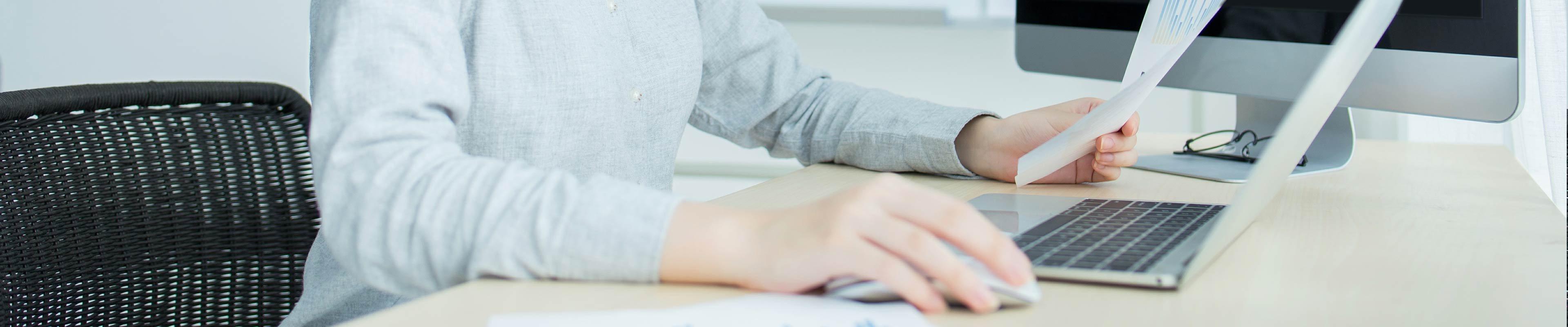 Woman at computer deducting charitable donations from taxes.