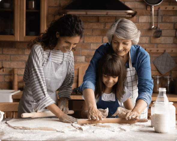 A family cooking together in a kitchen.