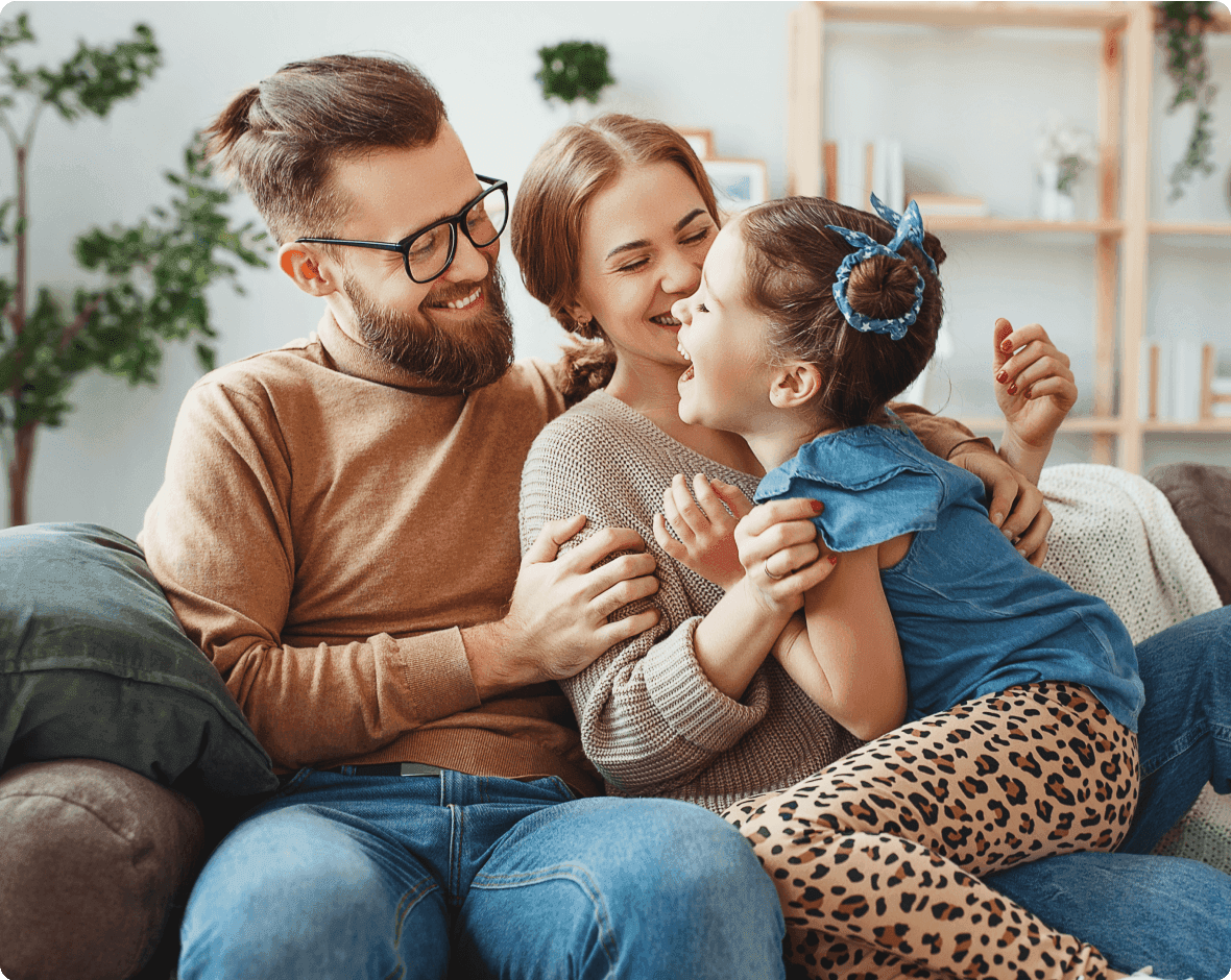 a man and woman holding a baby