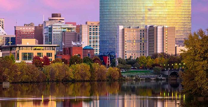 a body of water with trees and buildings around it