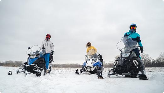 a group of people on snowmobiles