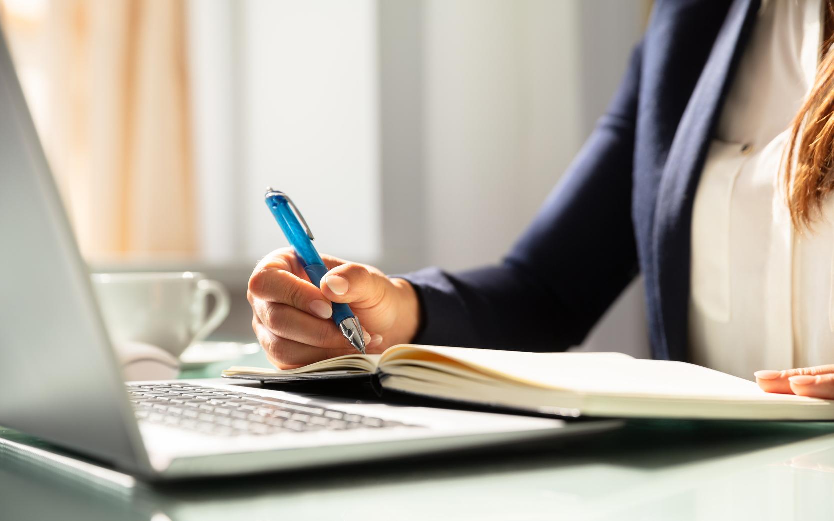 a woman writing on a book